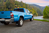 AUT 14 BK0072 01
2011 Toyota Tacoma Double Cab Pickup Truck Blue 3/4 Rear View On Gravel By River In Forest
