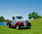 AUT 14 RK0085 02
1940 Chevrolet 1/2 Ton Truck Silver And Maroon 3/4 Front View On Grass By Water