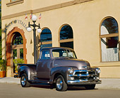 AUT 14 RK0103 02
1954 Chevrolet 3100 Truck Century Gray 3/4 Front View On Pavement By Building
