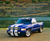 AUT 14 RK0176 06
1996 Dodge Truck Blue White Stripe 3/4 Front View On Dirt By Water