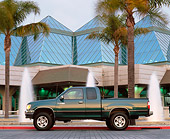 AUT 14 RK0217 09
1997 Toyota T-100 Truck Green Profile On Pavement By Water Fountain