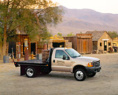 AUT 14 RK0283 03
1999 Ford F550 Flatbed Truck Champagne 3/4 Side View On Dirt