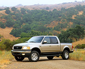 AUT 14 RK0405 03
2001 Ford F150 Super Crew 4x4 Pickup Truck Gold 3/4 Side View On Dirt By Hills