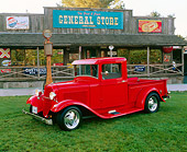 AUT 14 RK0438 02
1933 Ford Pickup Truck Red Side 3/4 View On Grass By Store