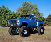 AUT 14 RK0441 02
1976 GMC 4x4 Pickup Truck Blue 3/4 Side View On Grass By Trees