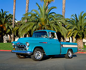 AUT 14 RK0496 04
1957 Chevy Cameo Pick Up Truck Blue Low 3/4 Side View On Pavement By Palm Trees Blue Sky