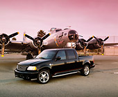 AUT 14 RK0546 02
2001 Ford F-150 Harley Davidson Edition Black 3/4 Side View On Pavement By Plane Red Sky