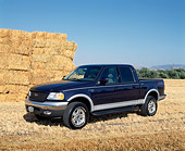 AUT 14 RK0711 02
2002 Ford F-150 Lariat Blue Front 3/4 View On Dry Grass By Hay