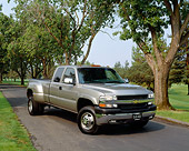 AUT 14 RK0736 04
2002 Chevy 3500 Dually Pick Up Pewter 3/4 Front View On Pavement By Trees And Grass