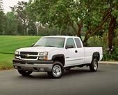 AUT 14 RK0752 07
2003 Chevy 2500HD Extended Cab Pick Up Truck White 3/4 Front View On Pavement By Grass Hill And Trees