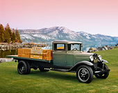 AUT 14 RK1034 01
1931 Ford Model AA Truck Green And Black 3/4 Front View On Grass By Lake And Mountains