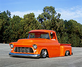 AUT 14 RK1124 03
1955 Chevrolet Stepside Pick Up Truck Tangelo 3/4 Front View On Pavement Blue Sky Trees