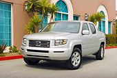 AUT 14 RK1130 01
2006 Honda Ridgeline RTL Silver 3/4 Front View On Pavement By Building