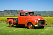 AUT 14 RK1196 01
1953 GMC 3/4 Ton Pick Up Truck Red 3/4 Side View On Grass By Wildflowers And Hills