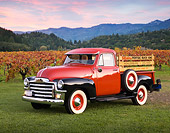 AUT 14 RK1220 01
1954 GMC Hydramatic 100 Pick Up Truck Red And Black 3/4 Side View On Grass By Crops At Dusk