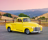AUT 14 RK1557 01
1950 Chevrolet Pickup Truck Yellow 3/4 Front View On Pavement By Hills