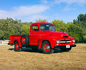 AUT 14 RK1563 01
1954 International R110 Heavy Duty 1/2 Ton Pickup Truck Red 3/4 Front View On Dry Grass By Trees