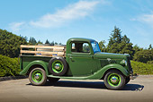 AUT 14 RK1706 01
1935 Ford Pickup Green With Barrels Profile View On Pavement By Trees