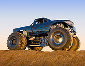 AUT 14 RK1737 01
2011 Dodge Ram Monster Truck Black With Blue Flames 3/4 Side View On Dirt Hill