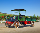 AUT 14 RK1784 01
1917 International Harvester Truck Model F 2 Ton Red, Black And Green 3/4 Side View On Dirt By Fence