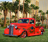 AUT 14 RK1799 01
1940 Chevrolet Pickup Red With Grim Reaper Graphic 3/4 Front View On Grass By Palm Trees