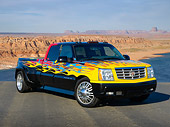 AUT 14 RK1800 01
2006 Cadillac Escalade XXL Black With Yellow, Blue And Red Flames 3/4 Front View On Pavement In Desert