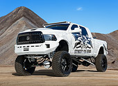 AUT 14 RK1802 01
2012 Dodge Ram Mega Cab White With Graphics 3/4 Front View On Sand By Pile Of Gravel
