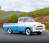 AUT 14 BK0006 01
1957 Dodge Sweptside Pickup Truck Blue And White 3/4 Front View On Road By Hillside
