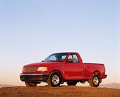 AUT 14 RK0036 03
1999 Ford F150 Lariat with Triton V8 Red 3/4 Side View On Dirt Hill Blue Sky