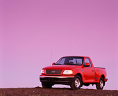 AUT 14 RK0039 03
1999 Ford F150 Lariat with Triton V8 Red 3/4 Front View On Dirt Hill At Dusk