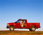 AUT 14 RK0042 03
1999 Ford F250 XLT Super Duty Red 4x4 Triton V10 Quad Door Profile View Doors Open On Dirt Hill Blue Sky