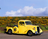 AUT 14 RK0099 04
1936 Ford 327 Yellow Truck Side 3/4 View On Pavement By Hill Clouds Blue Sky