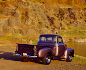AUT 14 RK0132 01
1954 Chevrolet 3100 1/2 Ton Truck Gray 3/4 Rear View On Dirt By Water