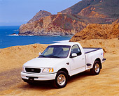 AUT 14 RK0155 08
1998 Ford F150 XLT Truck White 3/4 Front View On Sand By Water And Rocks