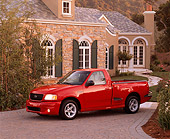 AUT 14 RK0211 01
1999 Ford F150 Lightning Truck Red 3/4 Side View On Driveway By House