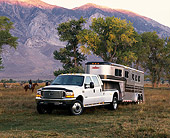 AUT 14 RK0292 09
1999 Ford F450 White With 5th Wheel And Trailer 3/4 Front View By Trees