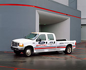 AUT 14 RK0331 04
2000 Ford F-450 Dually Truck White 3/4 Front View On Wet Pavement By Building