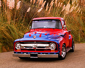 AUT 14 RK0452 01
1956 Ford F-100 Pick Up Truck Red With Blue Flames Front 3/4 View On Pavement By Tall Grass