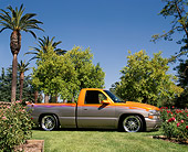 AUT 14 RK0539 03
2000 Chevrolet Silverado Pick Up Orange And Silver 3/4 Front View On Grass By Trees Blue Sky