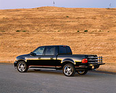 AUT 14 RK0550 05
2001 Ford F-150 Harley Davidson Edition Black 3/4 Rear View On Pavement By Dry Grass Hill