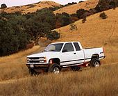 AUT 14 RK0588 02
1996 Chevy Z71 Silverado White 3/4 Side View On Dry Grass Hill At Dusk