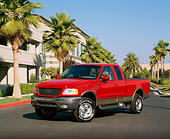AUT 14 RK0615 03
2001 Ford F-150 4x4 Off-Road Lariat Red 3/4 Front View On Pavement By Palm Trees Blue Sky