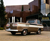 AUT 14 RK0661 01
1964 Chevrolet Corvair 95 Rampside Tan And White 3/4 Rear View On Pavement By Building