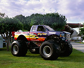 AUT 14 RK0735 09
Bigfoot Ford Monster Truck With Flames 3/4 Front View On Grass By Trees
