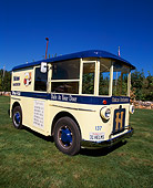 AUT 14 RK0781 07
1931 Twin Coach Helms Bakery Truck Yellow And Blue 3/4 Front View On Grass Blue Sky