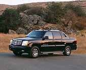 AUT 14 RK0789 01
2003 Cadillac Escalade EXT Black 3/4 Side View On Pavement By Dry Grass And Rocks