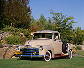 AUT 14 RK0952 01
1949 Chevy Pick Up Truck Tan 3/4 Front View On Grass By Bushes