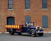 AUT 14 RK0976 02
1921 Hispano Suiza Truck Blue 3/4 Front View On Pavement By Brick Building