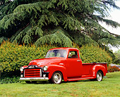 AUT 14 RK1061 03
1955 GMC 100 1st Series Red Custom Pick Up Truck Red Side 3/4 View On Grass Trees Background