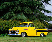 AUT 14 RK1064 02
1957 Chevy Cameo Carrier Pick Up Truck Yellow And Black 3/4 Side View On Grass Trees Background